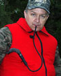Bowgrunter Plus Deer Call mounted on outer clothing.